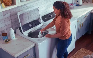 Woman using top load washers with agitators at home.