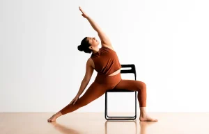Woman doing chair yoga in a modern studio space