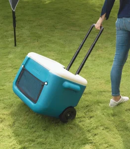 Portable Coleman cooler on wheels for outdoor activities