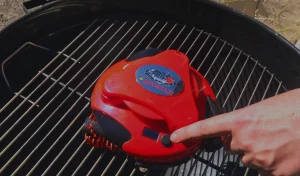 Close-up of Grillbot reviews with robot cleaning grill grates