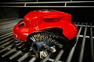 Grillbot reviews showing automatic grill cleaner in use