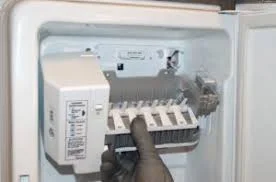 Technician performing ice maker repair