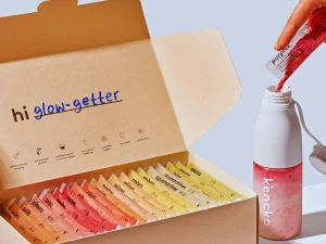Kencko Smoothie box with colorful packets and shaker bottle in use.