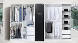 Black steam closet integrated in modern white wardrobe system