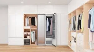 Steam closet inside modern white wardrobe with hanging clothes