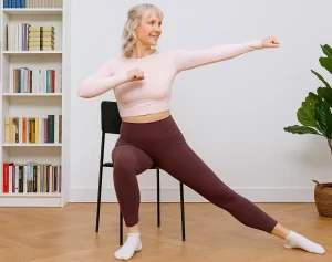 Woman doing chair workout in living room space