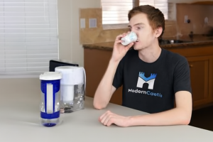 Man drinking water at table