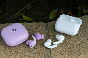 Beats vs AirPods on stone surface