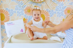 Smiling baby with Coterie Diaper