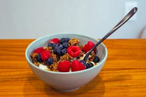 Bowl of All Cereals with fresh berries and yogurt.