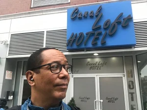 Man posing in front of Canal Loft Hotel New York