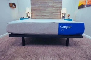 Casper Mattress One placed on a sleek black bed frame
