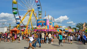 Crowds enjoying colorful carnival attractions at Expo St Hyacinthe