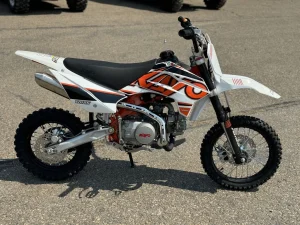 Kayo TD125 dirt bike parked on asphalt with bold orange