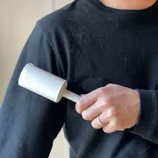 Using lint roller on black shirt