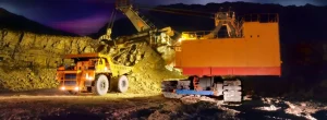 Heavy mining truck and excavator working at night