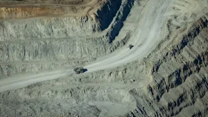 Haul trucks driving on winding road inside