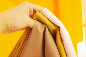 Poplin Laundry hand holding colorful fabric swatches