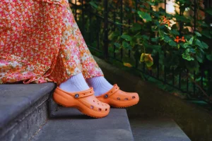 Crocs Comfortable orange clogs styled with floral dress