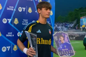 Nico Paz holding MVP trophy and FUT card at EA Sports event