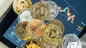 Close-up of crypto coins with a trading chart