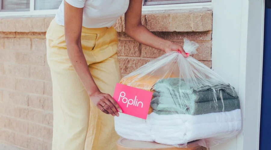 Poplin Laundry pickup with folded clothes outside home