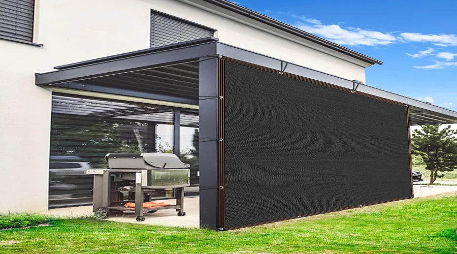 Black shade cloth attached to a modern patio structure